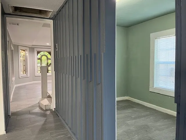 a view of an entryway with wooden floor and door