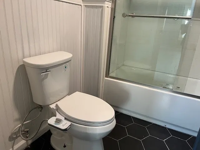 a white toilet sitting next to a bathroom sink