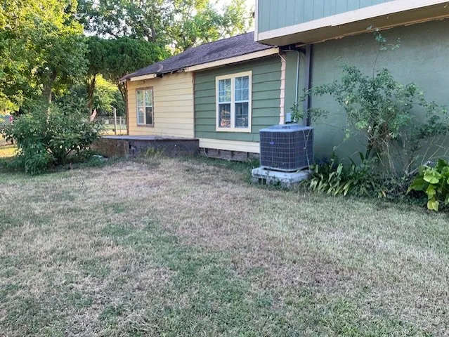a view of a house with a yard and potted plants