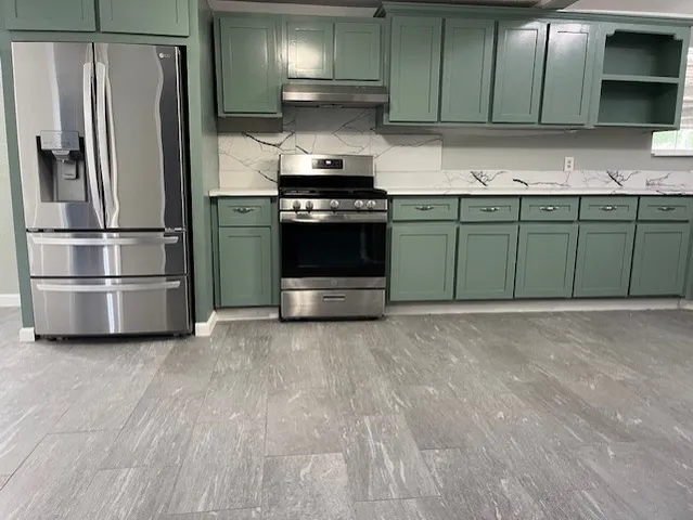 a kitchen with a sink and stainless steel appliances