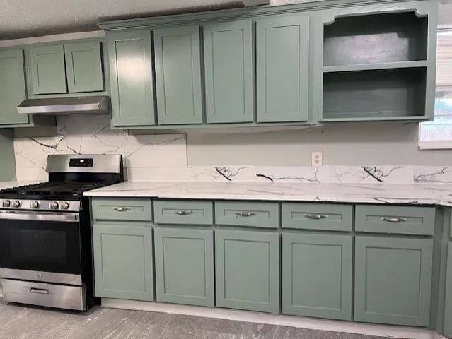 a kitchen with cabinets and white stainless steel appliances