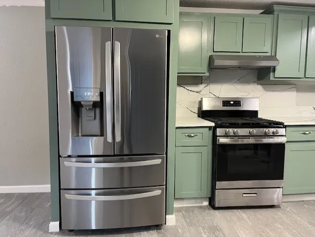 a kitchen with granite countertop stainless steel appliances and wooden cabinets