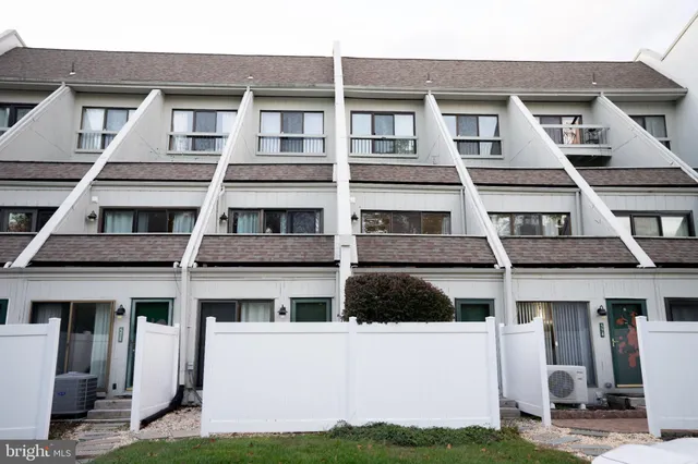 a front view of a building with a yard