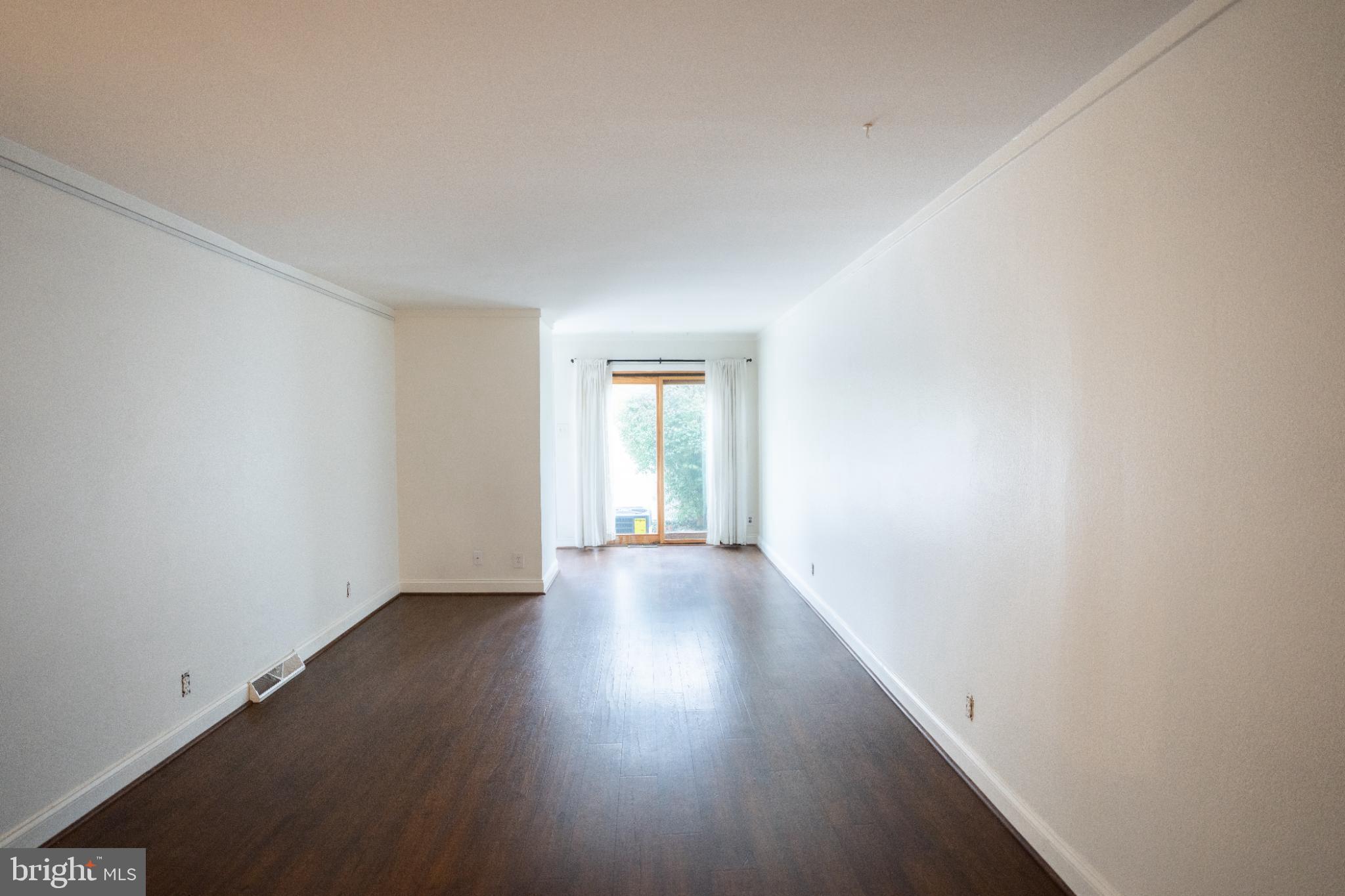 573 Summit House West Chester, PA 19382 - Photo 6 of 20 a view of an empty room with wooden floor and a window