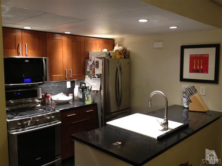 4549 Alamo Street, Unit B Simi Valley, CA 93063 - Photo 3 of 5 a kitchen with stainless steel appliances granite countertop a refrigerator and a stove