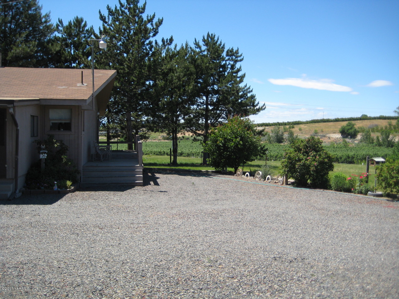 4572 Lombard Loop Road Zillah, WA 98953 - Photo 32 of 33 a view of a house with backyard and a tree