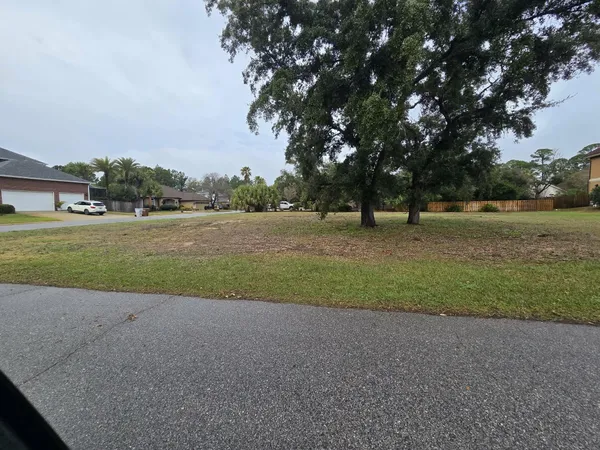 a view of outdoor space with green field and trees