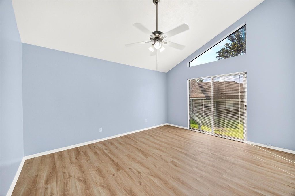 17 April Point Drive North Conroe, TX 77356 - Photo 26 of 42 a view of an empty room with wooden floor and a window