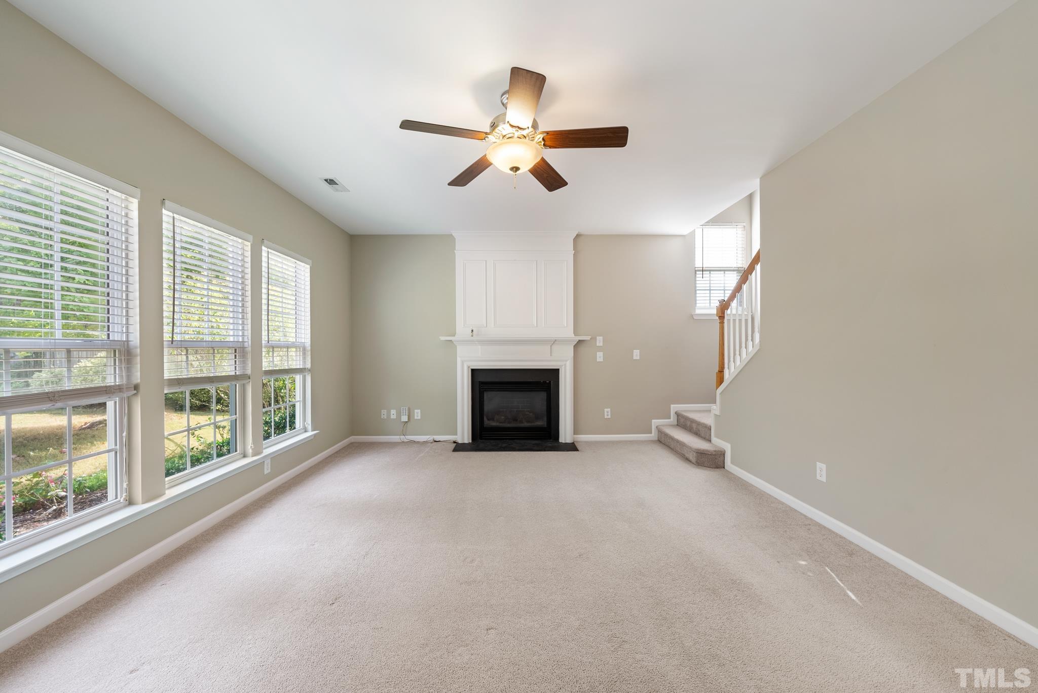 7432 Silver View Lane Raleigh, NC 27613 - Photo 12 of 28 a view of empty room with fireplace and windows