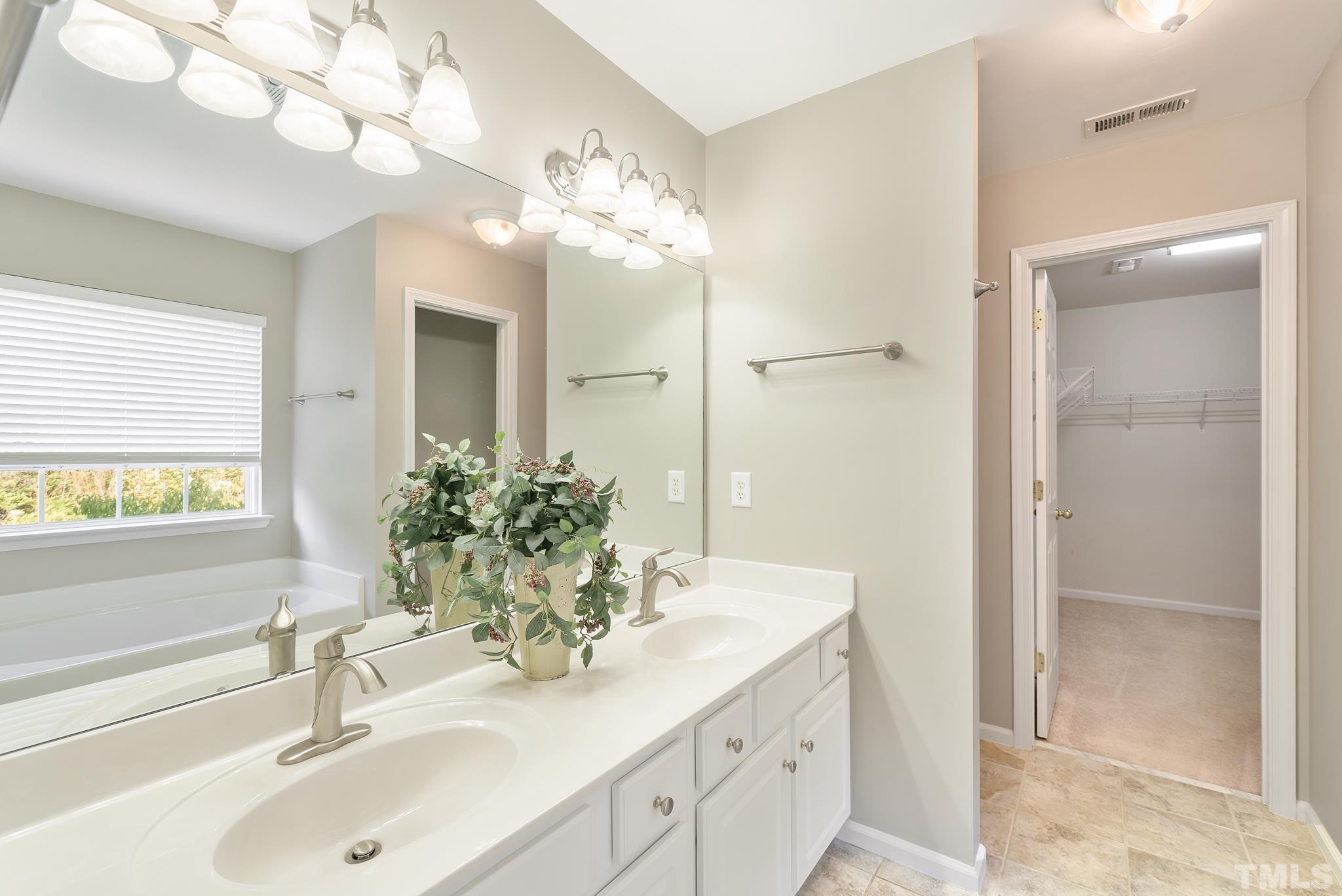7432 Silver View Lane Raleigh, NC 27613 - Photo 16 of 28 a bathroom with a sink double vanity and a mirror