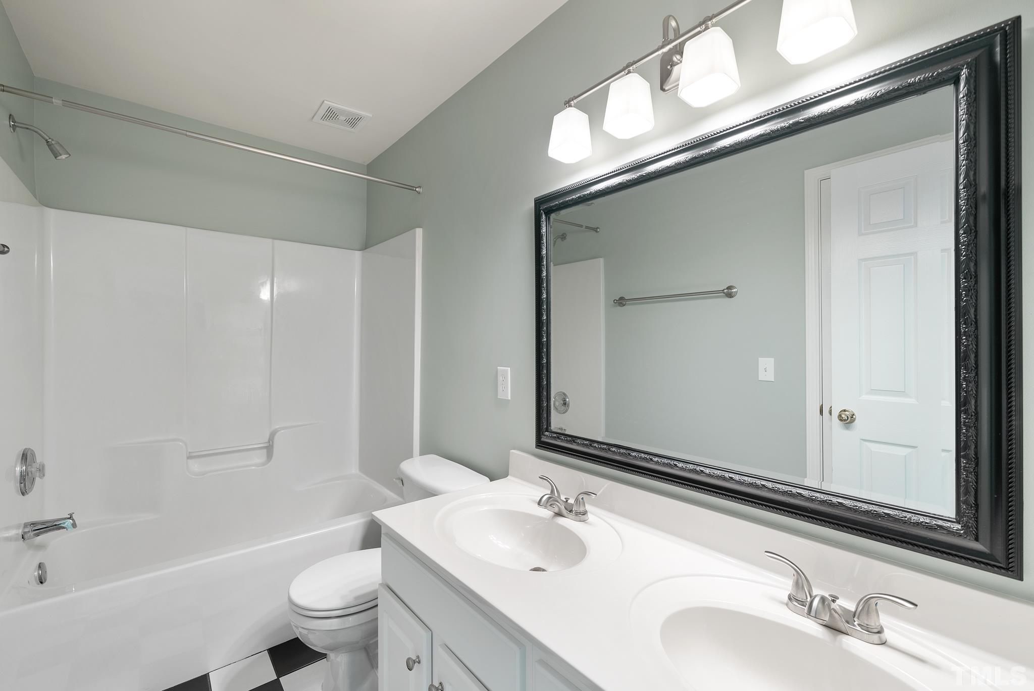 7432 Silver View Lane Raleigh, NC 27613 - Photo 20 of 28 a bathroom with a granite countertop sink toilet and shower
