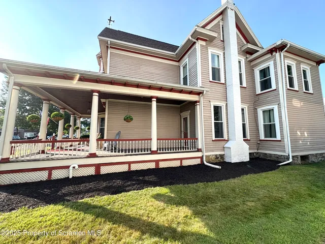 a front view of a house with a yard table and chairs