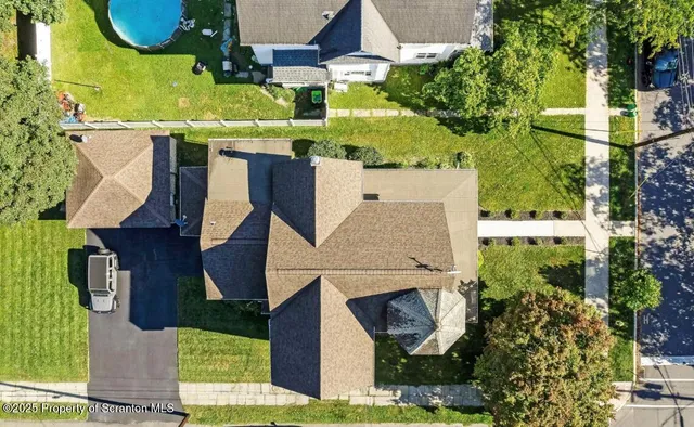 an aerial view of a house with a yard basket ball court and outdoor seating