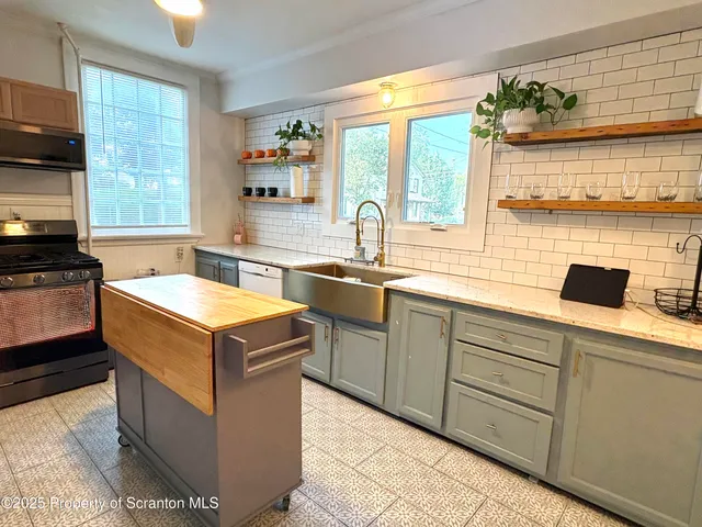 a kitchen with a sink and a stove top oven