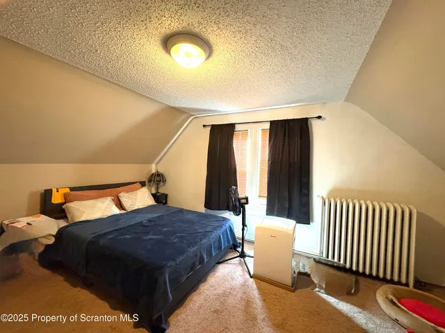 a bedroom with bed and window