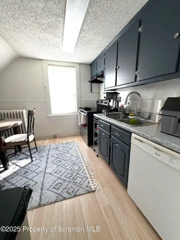 a kitchen with wooden cabinets and a stove top oven