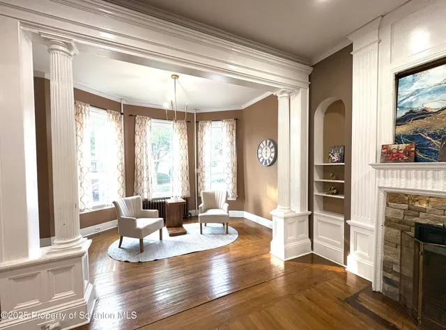 a living room with fireplace furniture and a large window