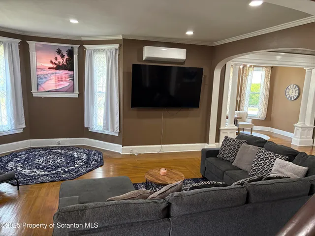 a living room with furniture and a flat screen tv
