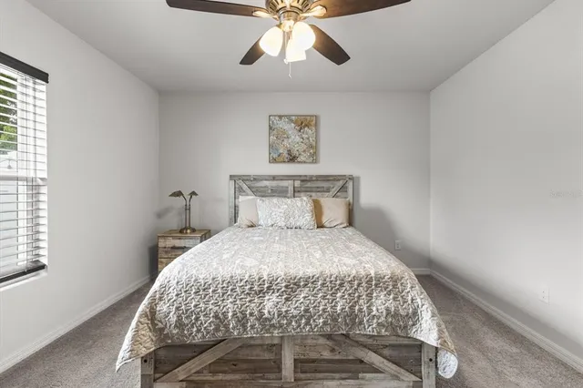 a bedroom with a bed and window