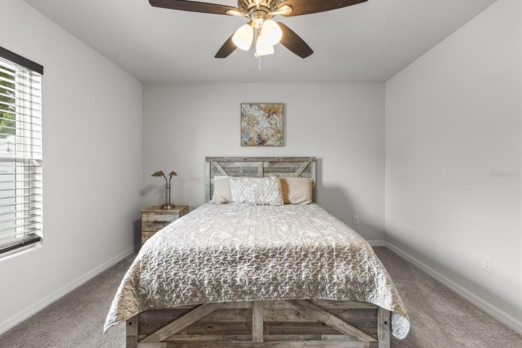 3332 Lambert Avenue Spring Hill, FL 34608 - Photo 13 of 30 a bedroom with a bed and window