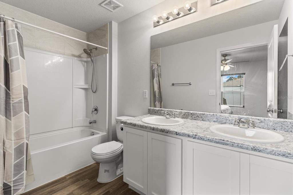 3332 Lambert Avenue Spring Hill, FL 34608 - Photo 16 of 30 a bathroom with a granite countertop sink toilet tub and shower