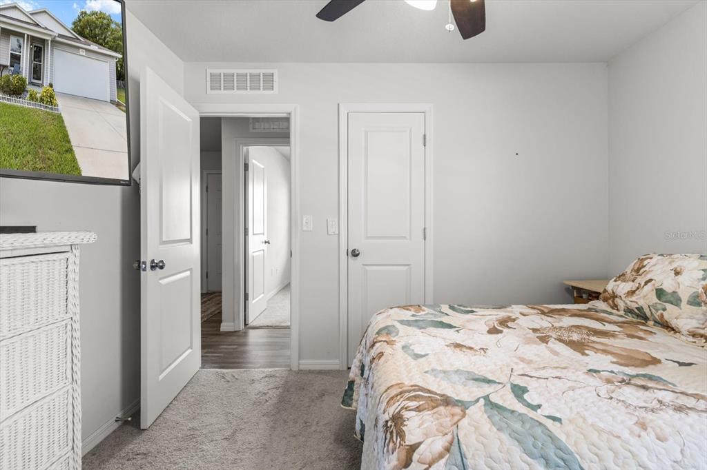 3332 Lambert Avenue Spring Hill, FL 34608 - Photo 18 of 30 a bedroom with a bed and cabinets