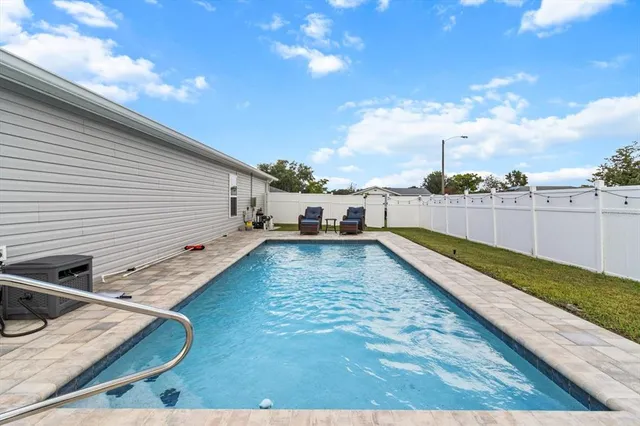 a backyard of a house with table and chairs