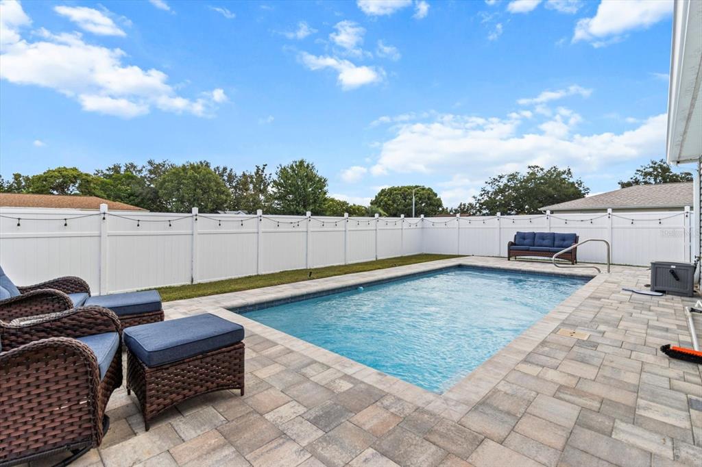 3332 Lambert Avenue Spring Hill, FL 34608 - Photo 29 of 30 a backyard of a house with table and chairs
