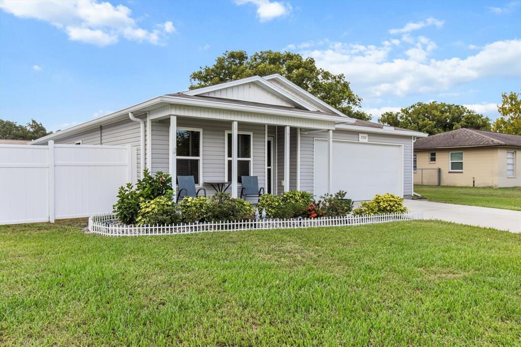 3332 Lambert Avenue Spring Hill, FL 34608 - Photo 3 of 30 a front view of a house with a garden