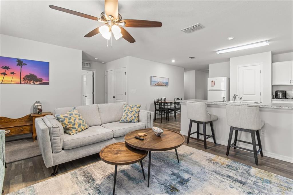 3332 Lambert Avenue Spring Hill, FL 34608 - Photo 5 of 30 a living room with furniture kitchen view and a chandelier