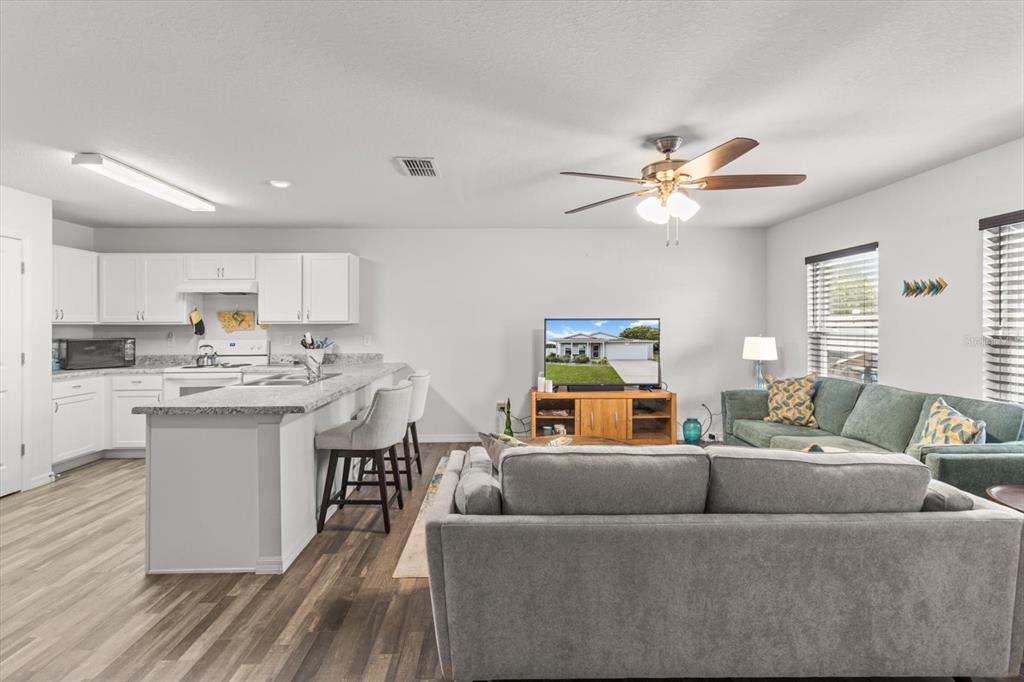 3332 Lambert Avenue Spring Hill, FL 34608 - Photo 7 of 30 a living room with furniture and kitchen view
