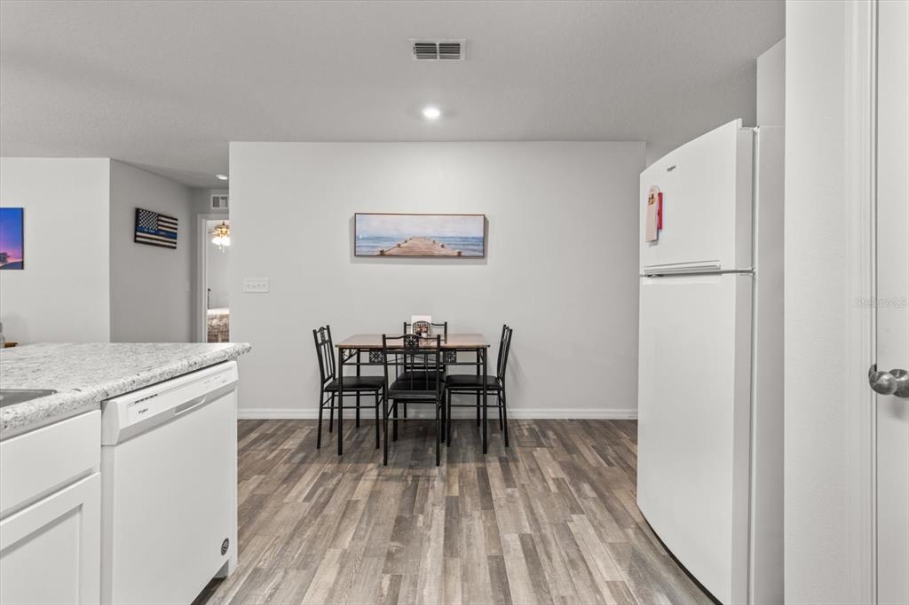 3332 Lambert Avenue Spring Hill, FL 34608 - Photo 9 of 30 a view of a dining room with furniture and wooden floor