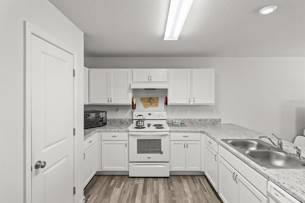 3332 Lambert Avenue Spring Hill, FL 34608 - Photo 10 of 30 a kitchen with white cabinets stainless steel appliances and sink