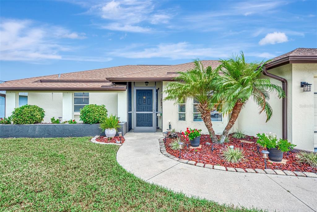 5871 Lincoln Road Venice, FL 34293 - Photo 1 of 1 a front view of a house with garden