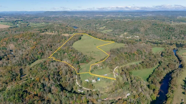 a view of a field with mountains in the background