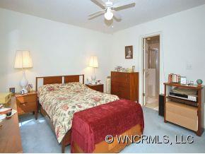 73 Forest Berry Road Fletcher, NC 28732 - Photo 5 of 7 a bedroom with a bed and a walk in closet