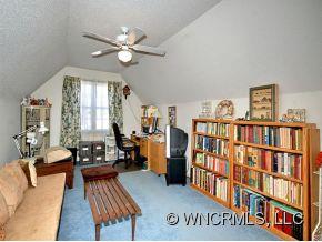 73 Forest Berry Road Fletcher, NC 28732 - Photo 6 of 7 a living room with lots of furniture and a book shelf