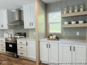 385 Page Road Godwin, NC 28344 - Photo 7 of 18 a kitchen with granite countertop white cabinets and window