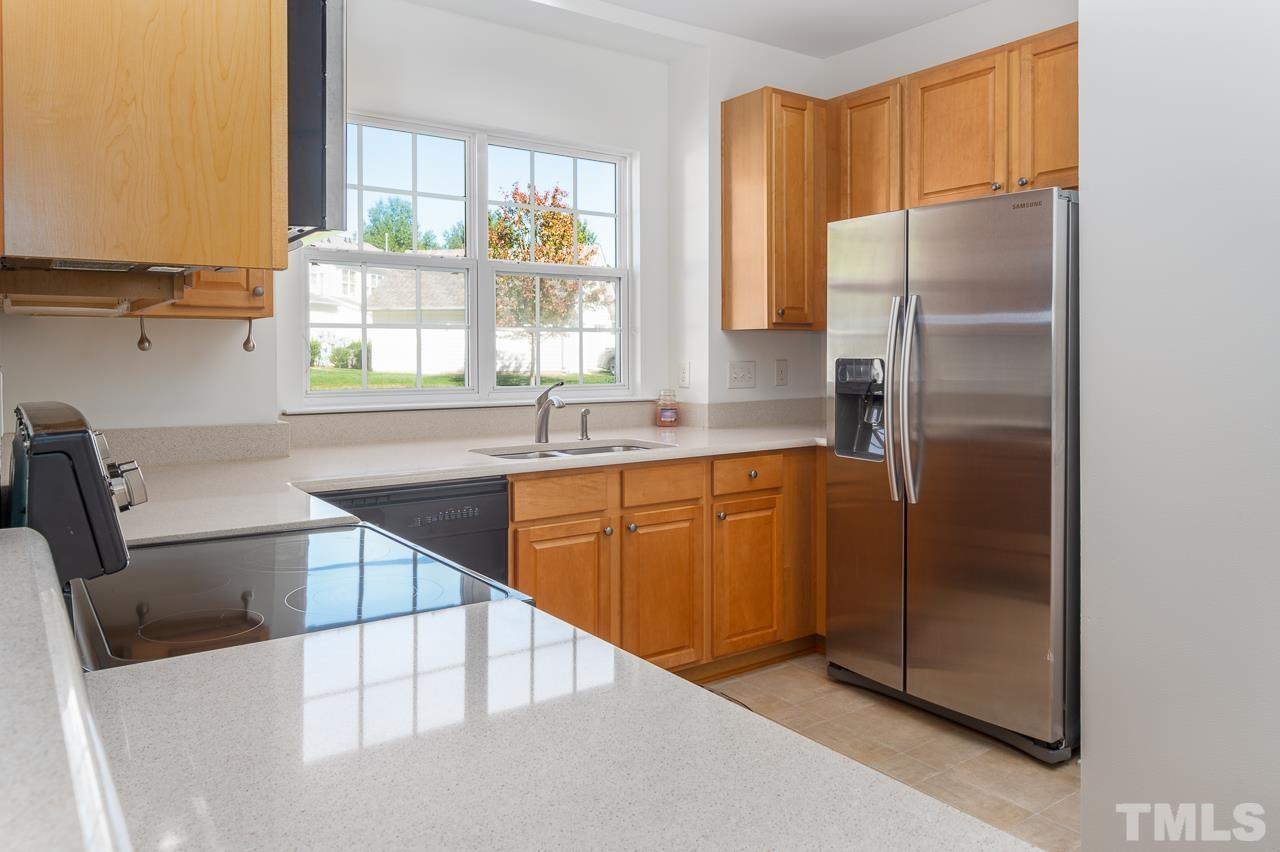 4 Cranbrook Court Durham, NC 27713 - Photo 11 of 30 a kitchen with stainless steel appliances granite countertop a refrigerator a sink and a stove