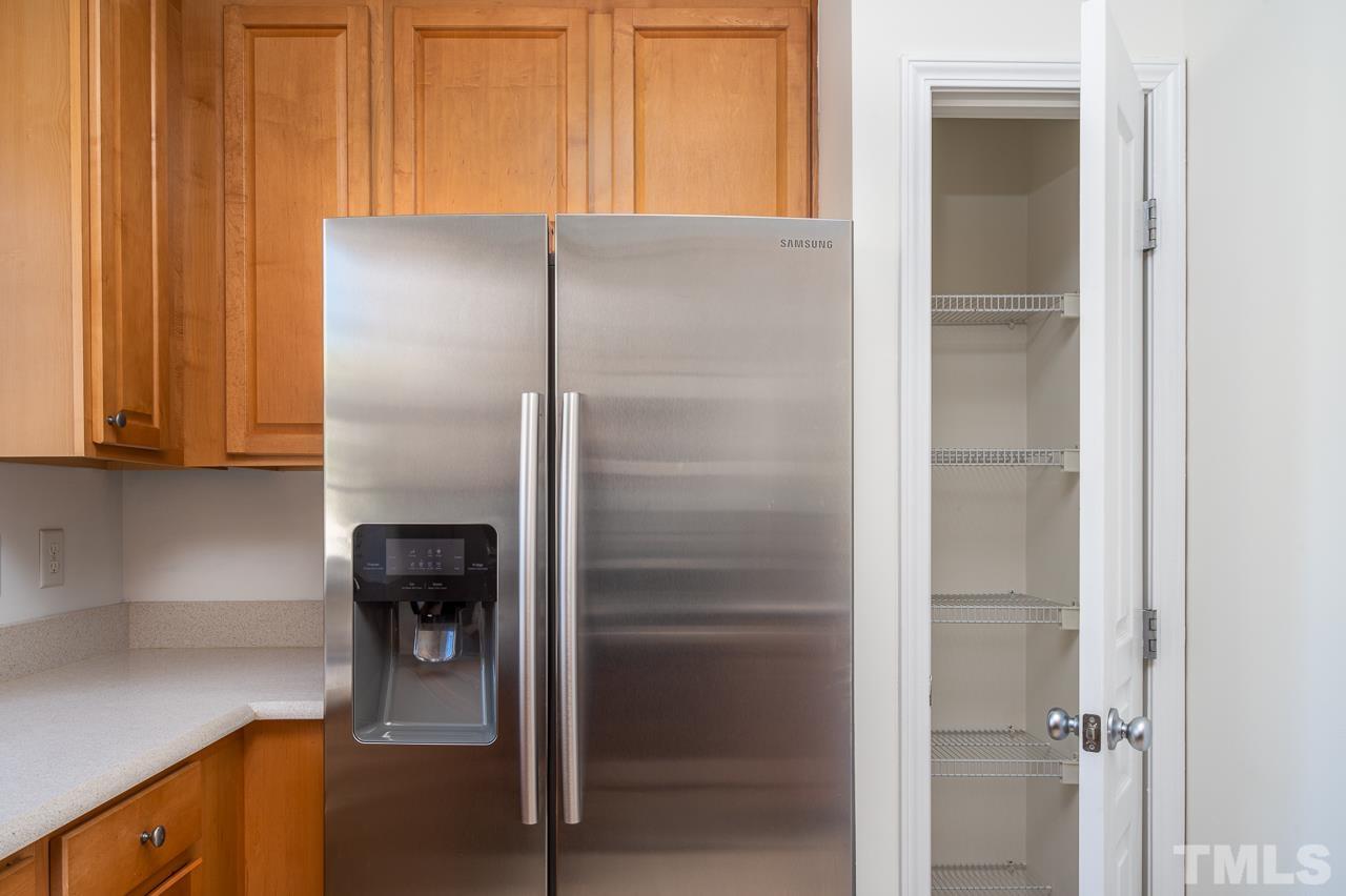 4 Cranbrook Court Durham, NC 27713 - Photo 14 of 30 a kitchen with a refrigerator and cabinets