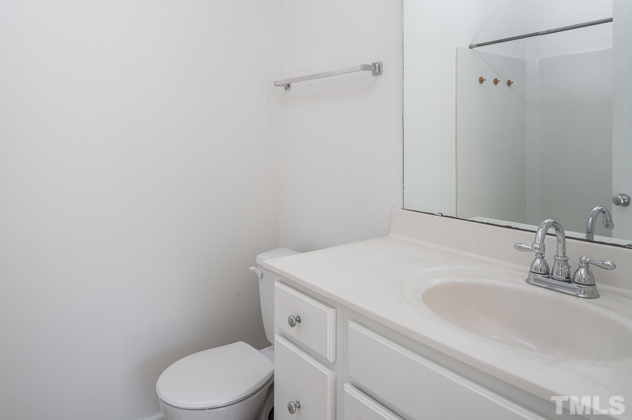 4 Cranbrook Court Durham, NC 27713 - Photo 19 of 30 a bathroom with a sink a toilet and a mirror