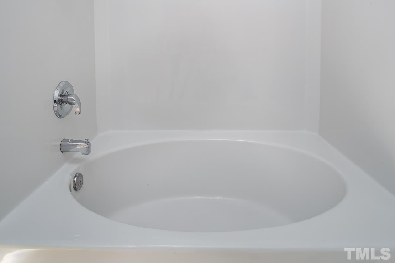 4 Cranbrook Court Durham, NC 27713 - Photo 20 of 30 a white bath tub sitting in a bathroom