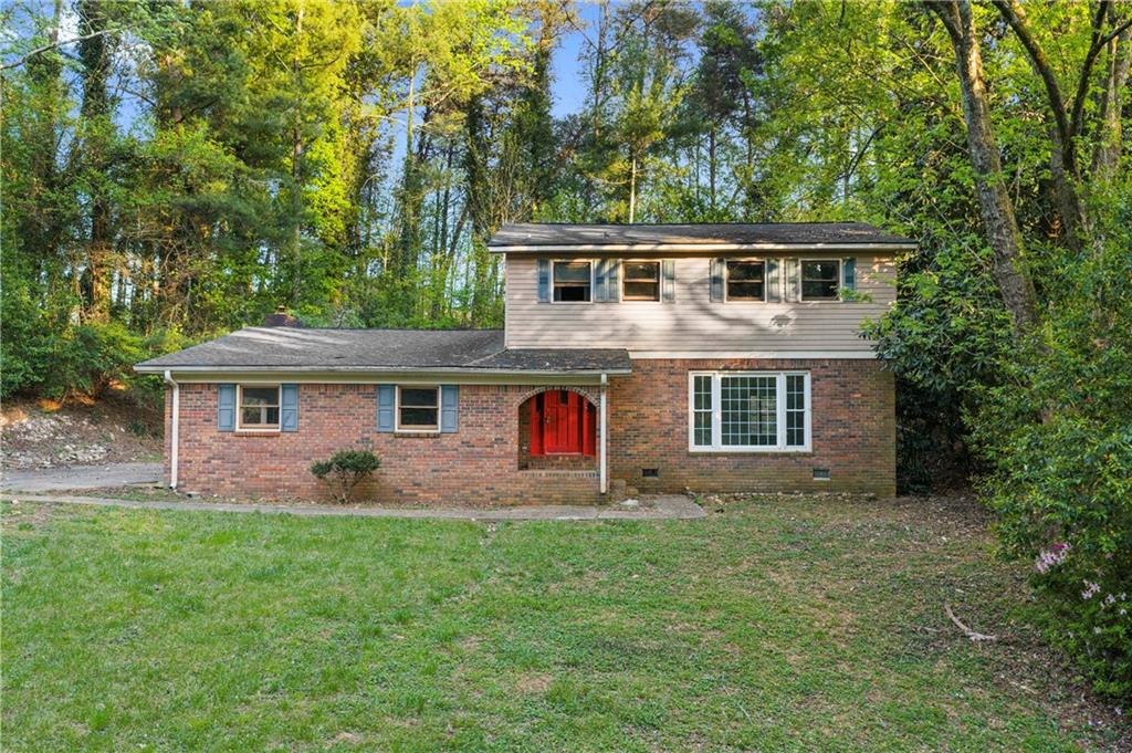 a front view of house with yard and green space