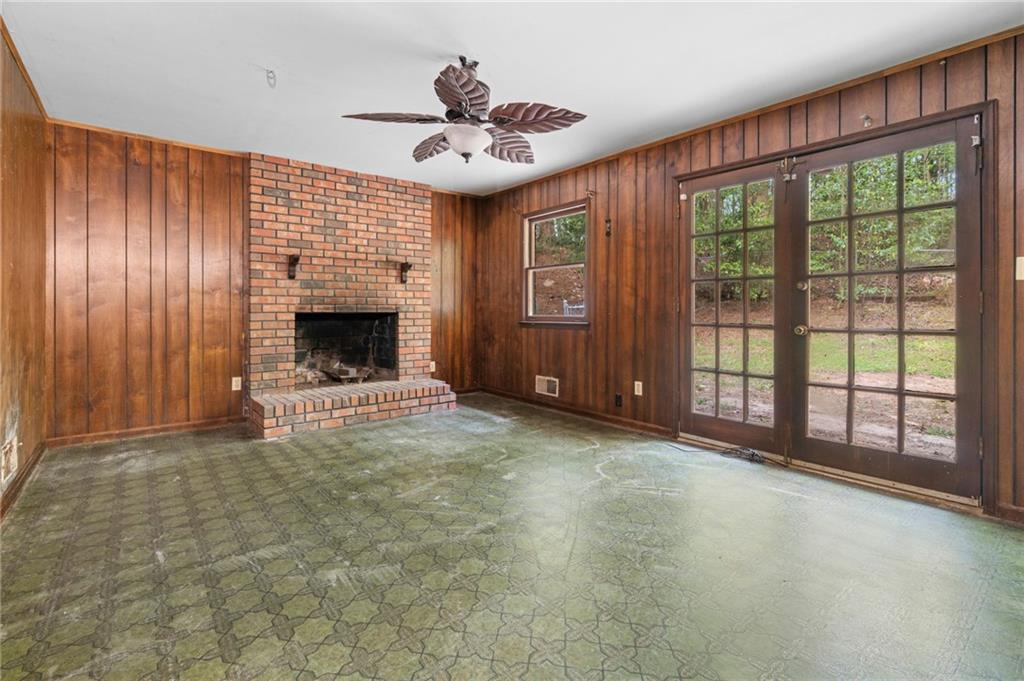 1973 Pinetree Trail Gainesville, GA 30501 - Photo 13 of 26 a view of an empty room with a fireplace and a large window