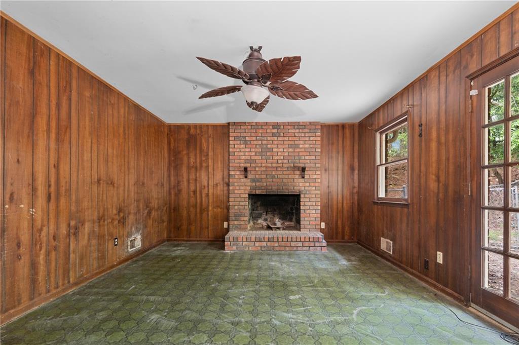 1973 Pinetree Trail Gainesville, GA 30501 - Photo 14 of 26 a living room with fireplace furniture a ceiling fan and a window