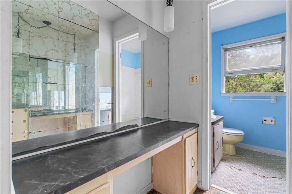 1973 Pinetree Trail Gainesville, GA 30501 - Photo 17 of 26 a bathroom with a granite countertop sink and a large mirror