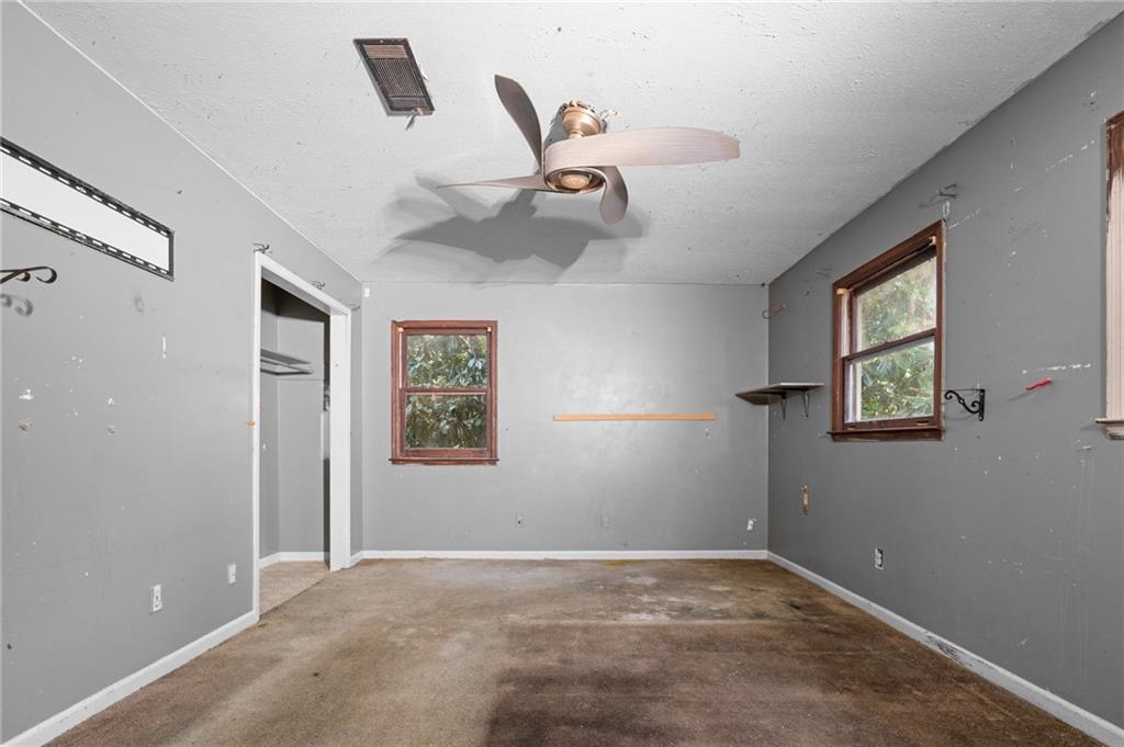 1973 Pinetree Trail Gainesville, GA 30501 - Photo 22 of 26 a view of empty room with windows and ceiling fan