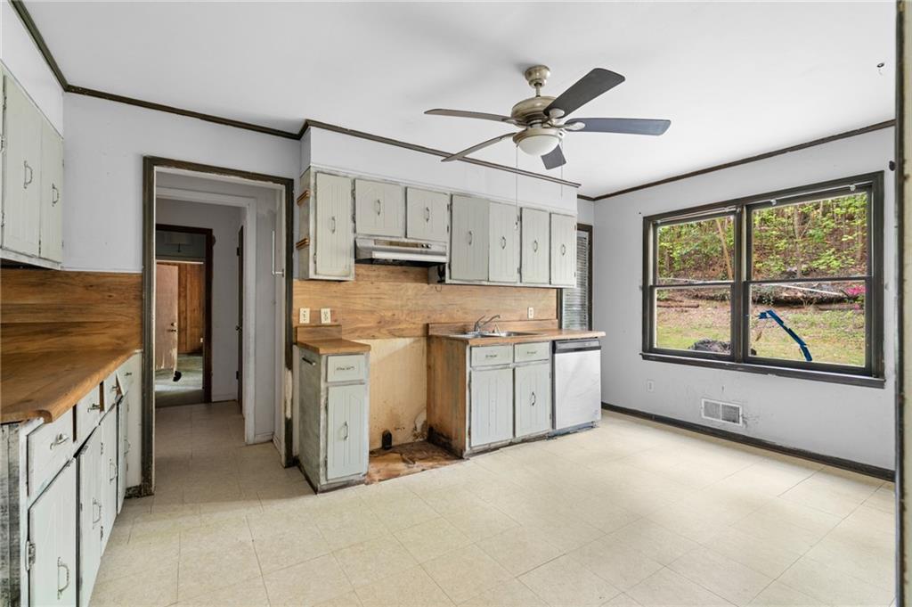 1973 Pinetree Trail Gainesville, GA 30501 - Photo 8 of 26 a open kitchen with white cabinets and white appliances