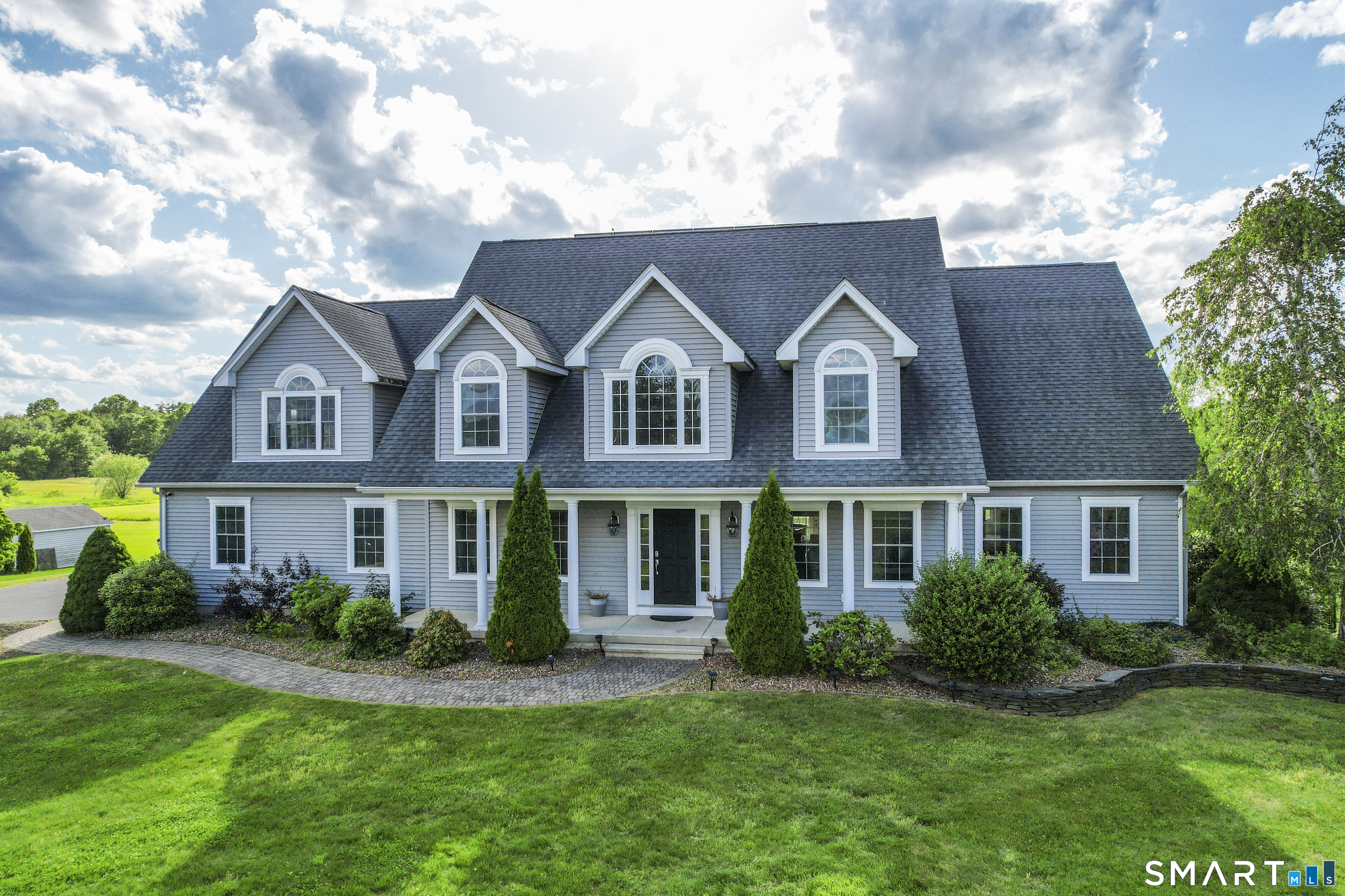 a front view of a house with a yard