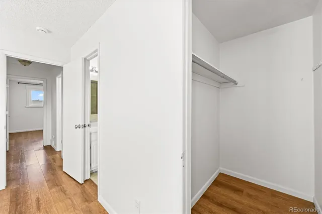 a view of a room with wooden floor